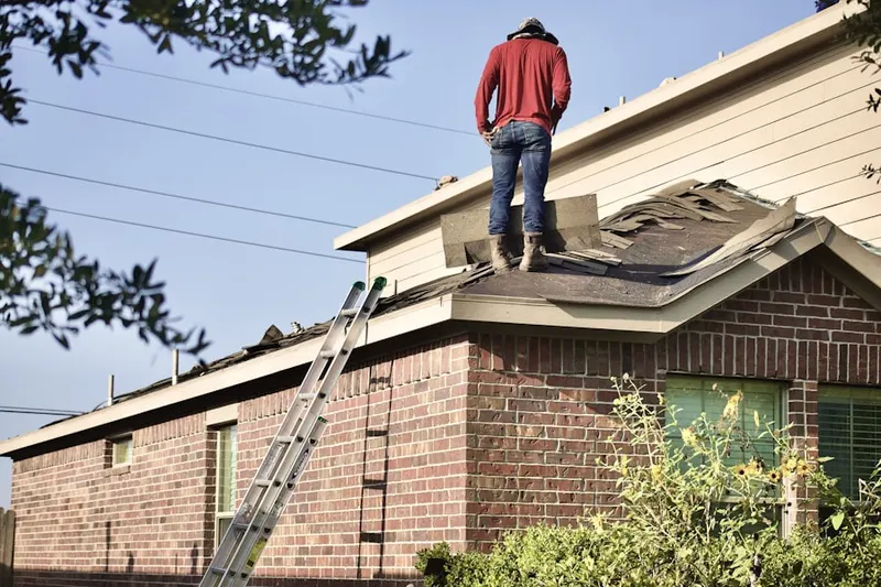 Professional roofer working on a residential roof in Rocky Nook Park